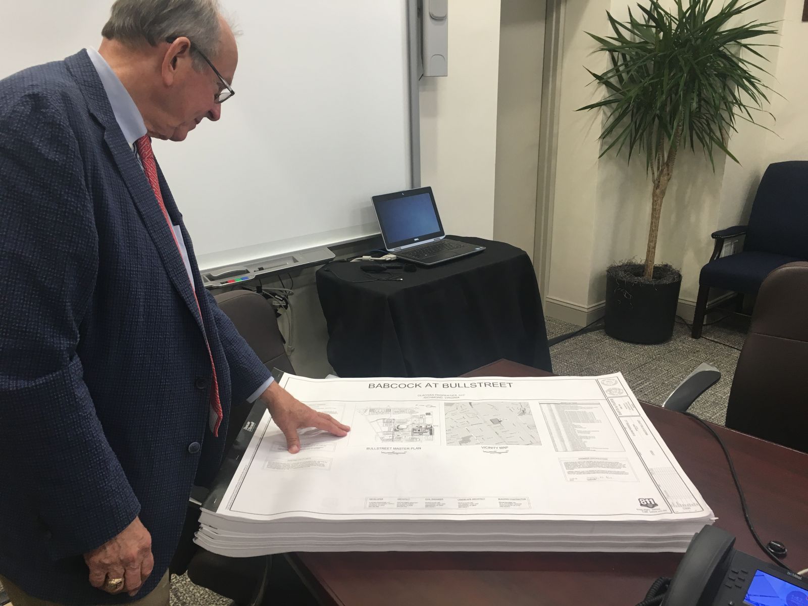 Columbia City Councilman Howard Duvall, chair of the Bull Street commission, examines plans for luxury apartments at the Babcock building in the BullStreet District. (Photo/RenÃ©e  Sexton)