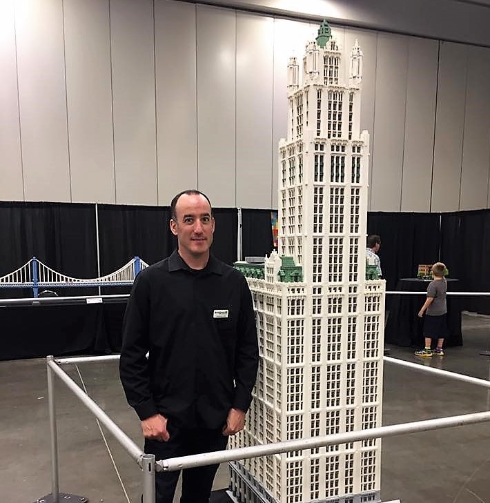 Lego artist Jonathan Lopes with his 8-foot replica of the Woolworth Tower in New York City. (Photo/Provided)