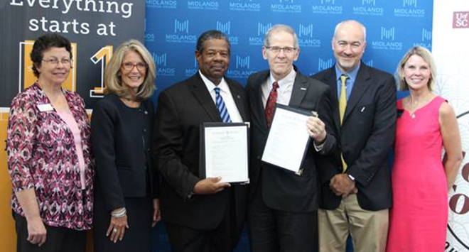 Midlands Technical College president Ron Rhames (third from left) joins officials from MTC and the University of South Carolina's Darla Moore School of Business on Tuesday to announce a new transfer agreement. (Photo/Provided)