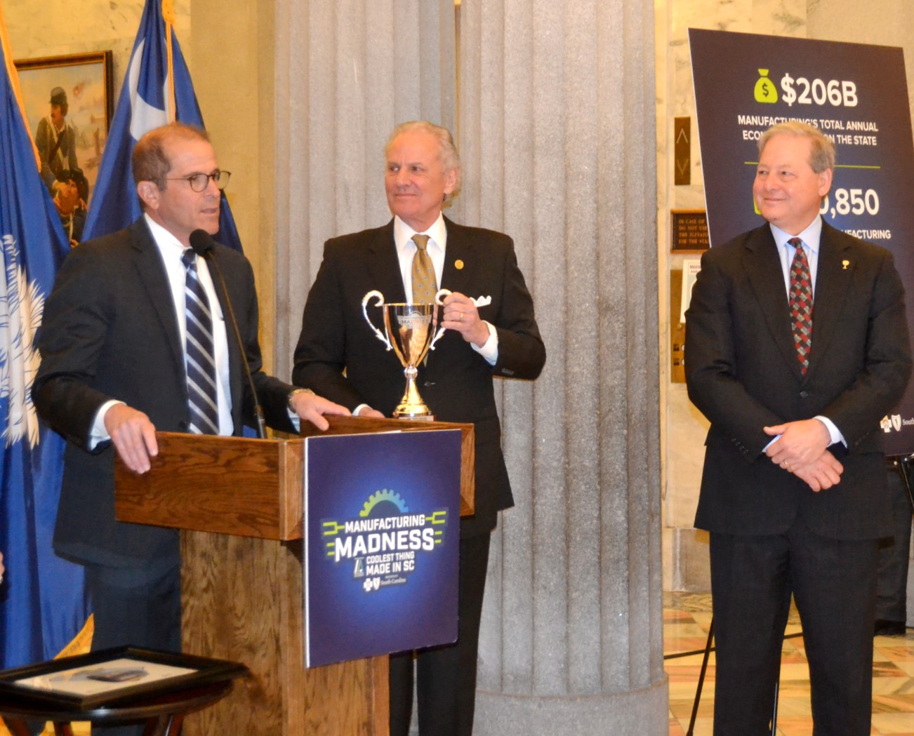 Mike Lee, vice president and general manager of Nucor Steel Berkeley, accepts the 'Coolest Thing Made in SC' trophy from S.C. Gov. Henry McMaster and S.C. Secretary of Commerce Harry Lightsey on Wednesday at the Statehouse. (Photo/Melinda Waldrop)