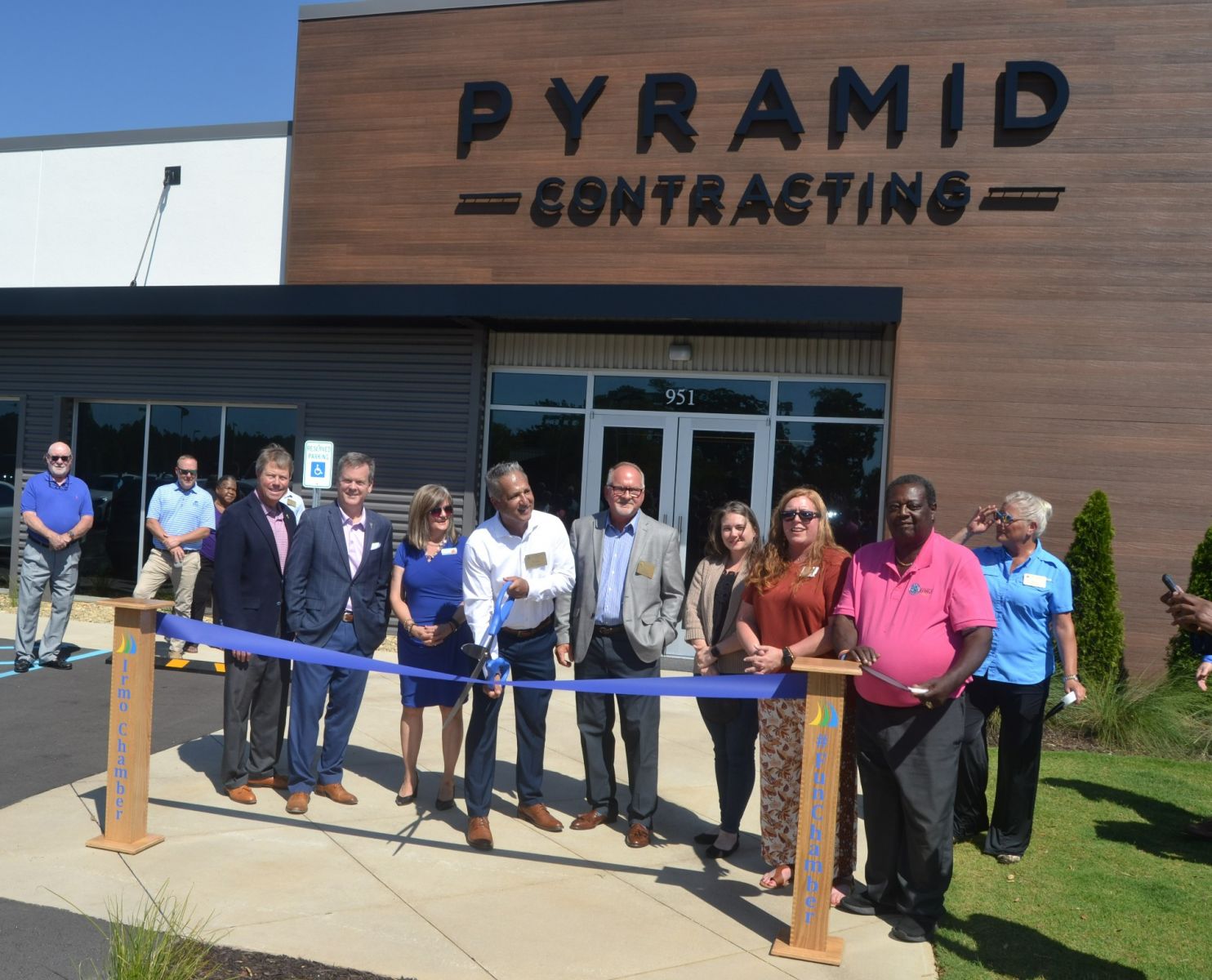 Bobby Alexander (center, with scissors), president of Pyramid Contracting, cuts the ribbon on the company's new Irmo headquarters on Wednesday. (Photo/Melinda Waldrop)