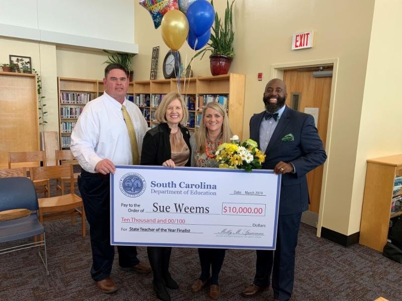 Blythewood High School English teacher Sue Weems (with flowers) has been selected as one of five finalists for the S.C. Teacher of the Year award. (Photo/Provided)