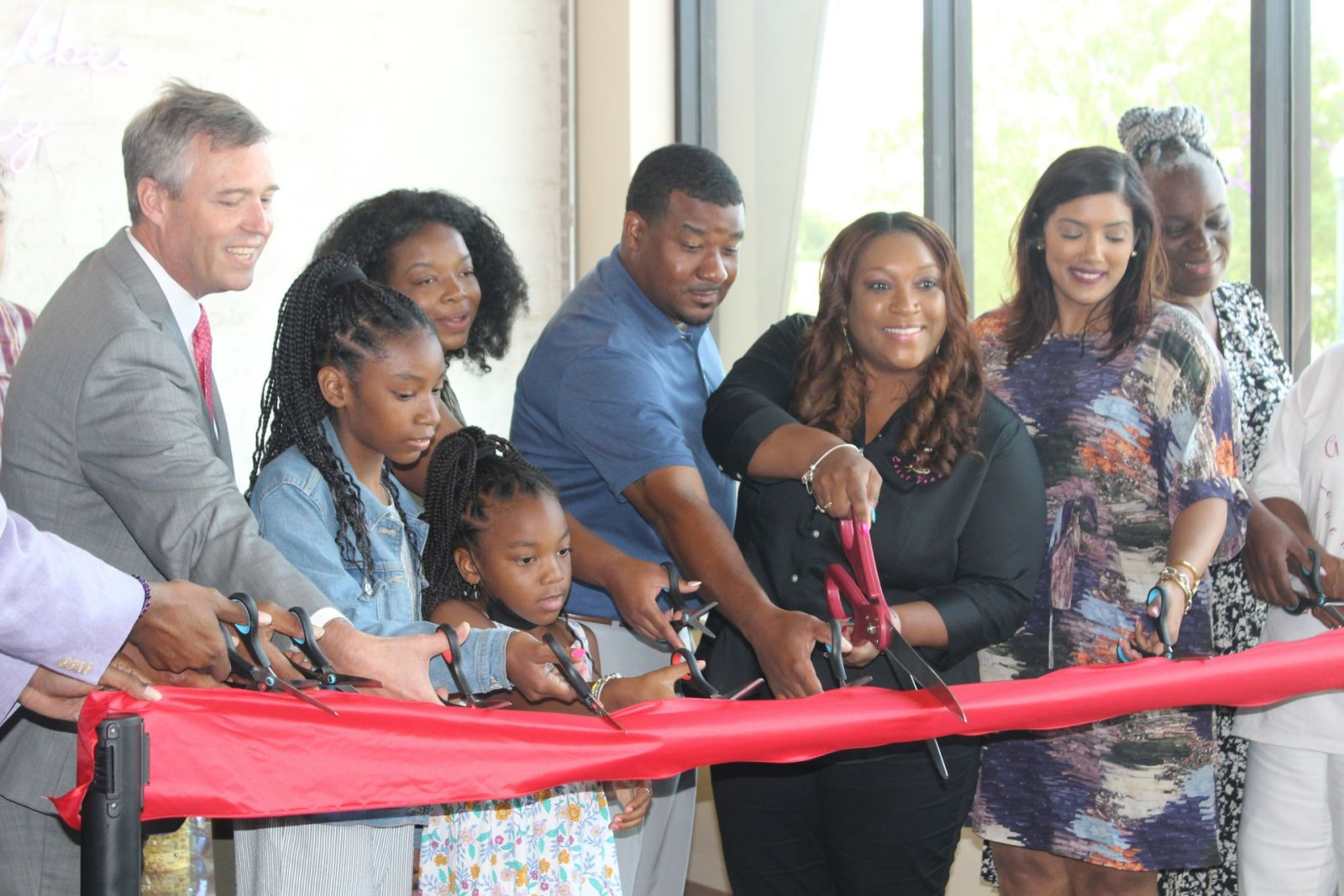 Irmo resident Ebony Livingston (with scissors), owner of Good Vibes Nibbles and Sips, cuts the ribbon on her new business at at 2510 Main St., Suite A, in the NOMA trestle district. (Photo/Christina Lee Knauss)